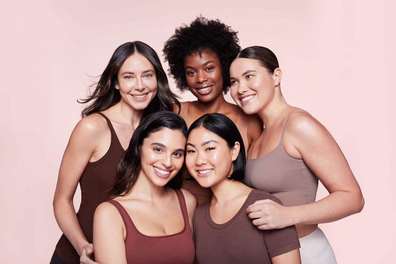 Woman smiling with her hands behind her head